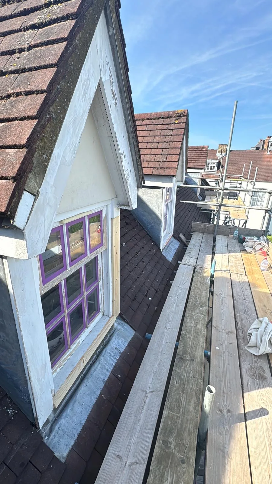 Dormer sash windows on a tiled London roof accessed from scaffolding