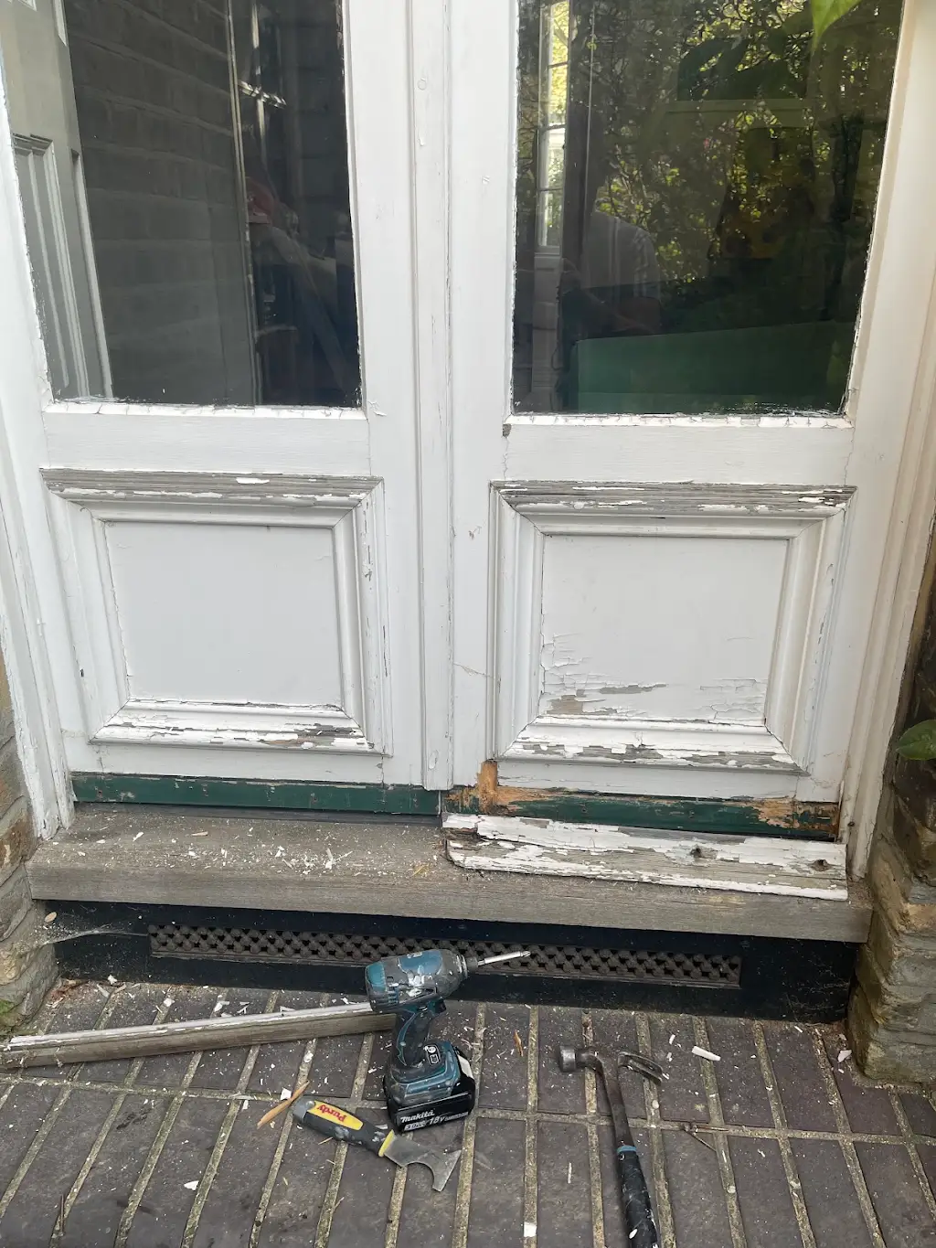 Victorian french garden doors with peeling paint and rotten timber sill before restoration