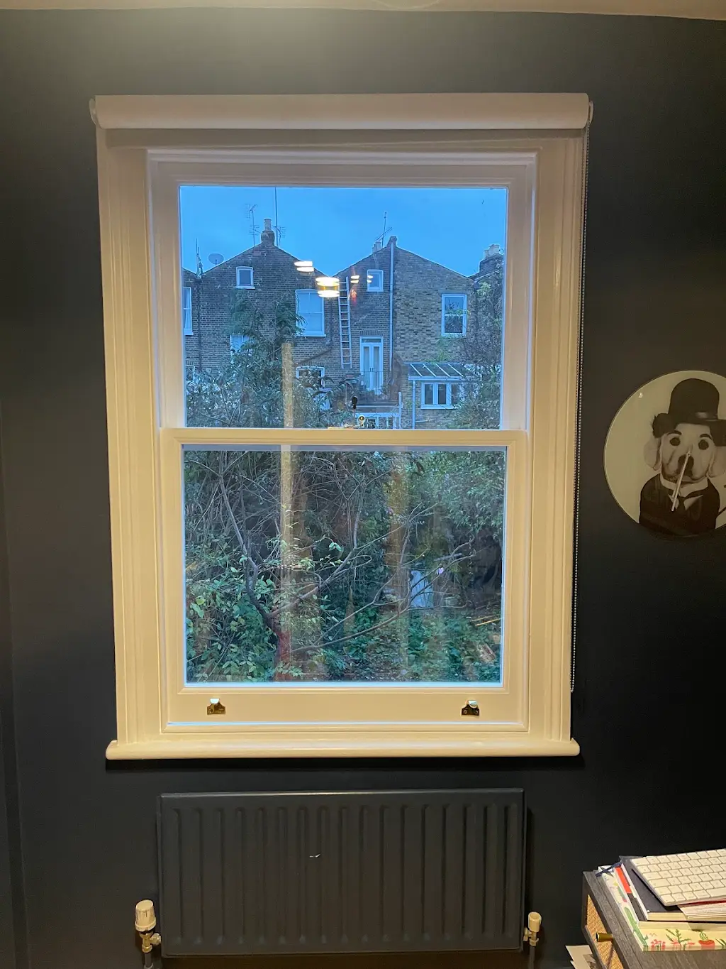 Cream sash window restored in a dark modern living room