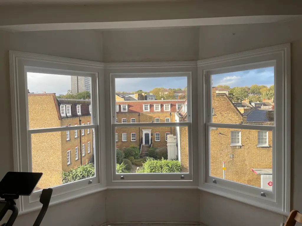 Bright interior with newly painted bay windows overlooking London