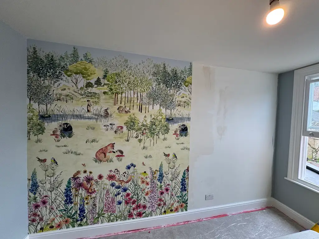 Botanical wallpaper feature wall paired with soft blue walls