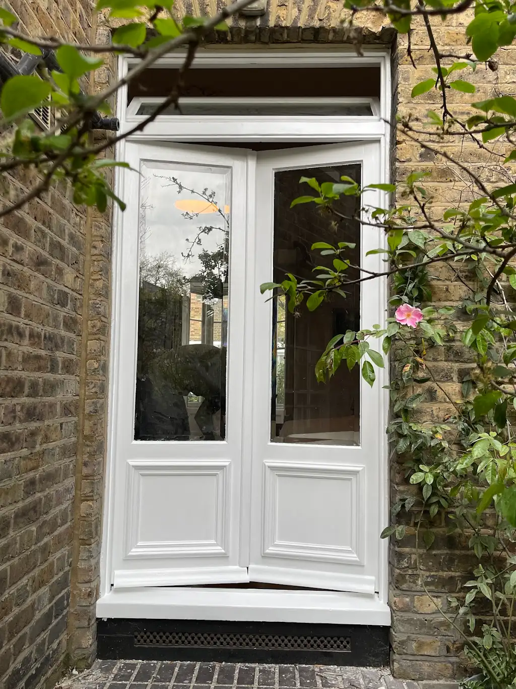 Restored Victorian french garden doors freshly repainted in white after full restoration