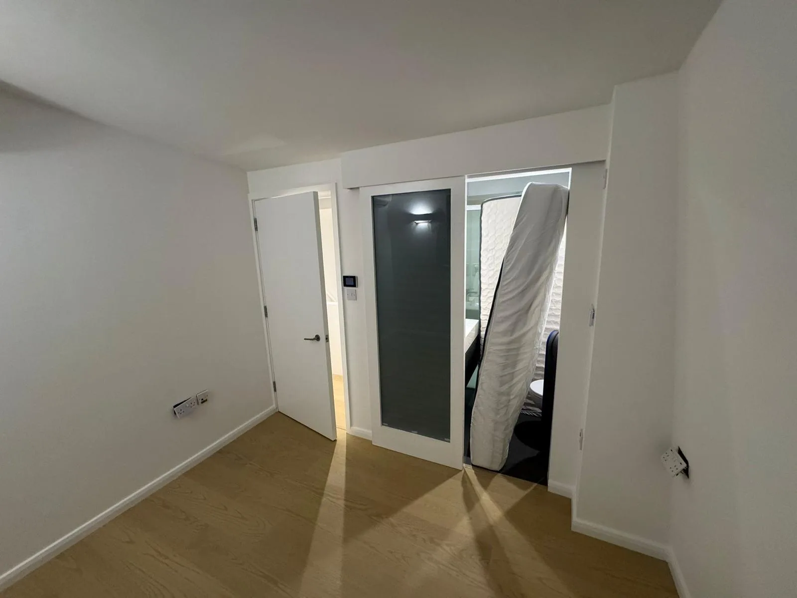 Freshly painted interior with sliding frosted glass door and crisp white walls