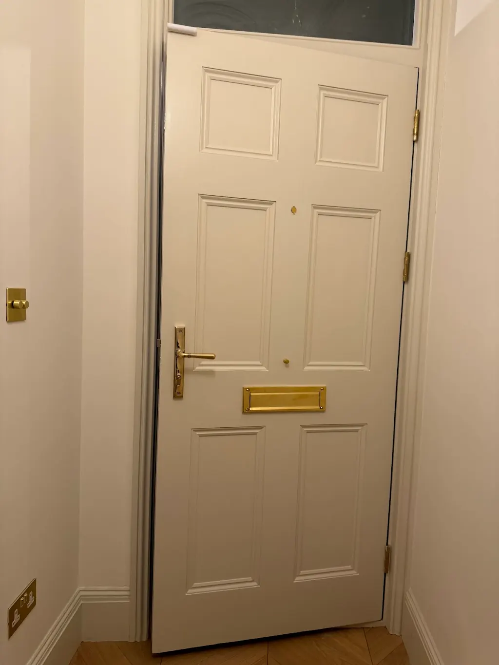 Cream interior door with brass letterbox and heritage handle