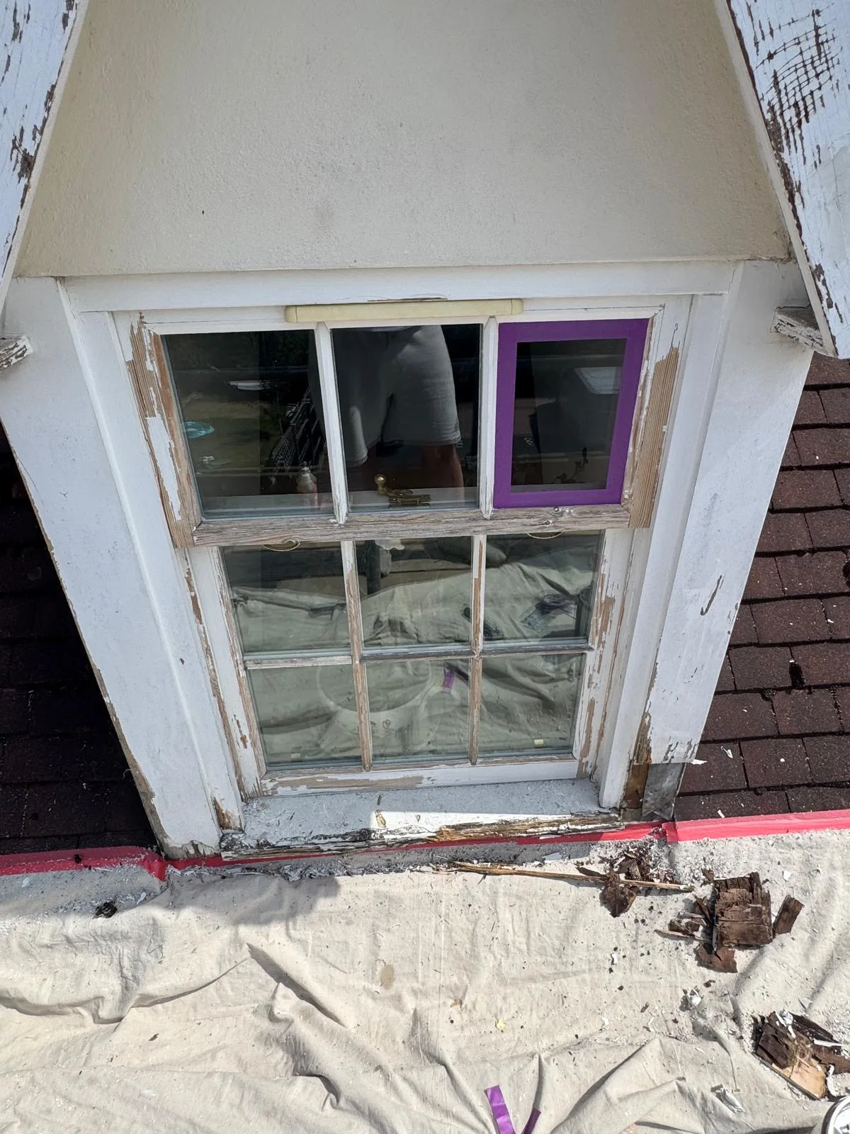 Dormer sash window mid-preparation with stripped timber and damaged sill