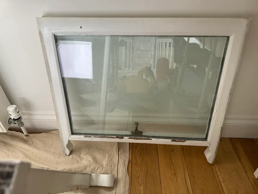 Large sash panel removed and prepped on dust sheets before repainting