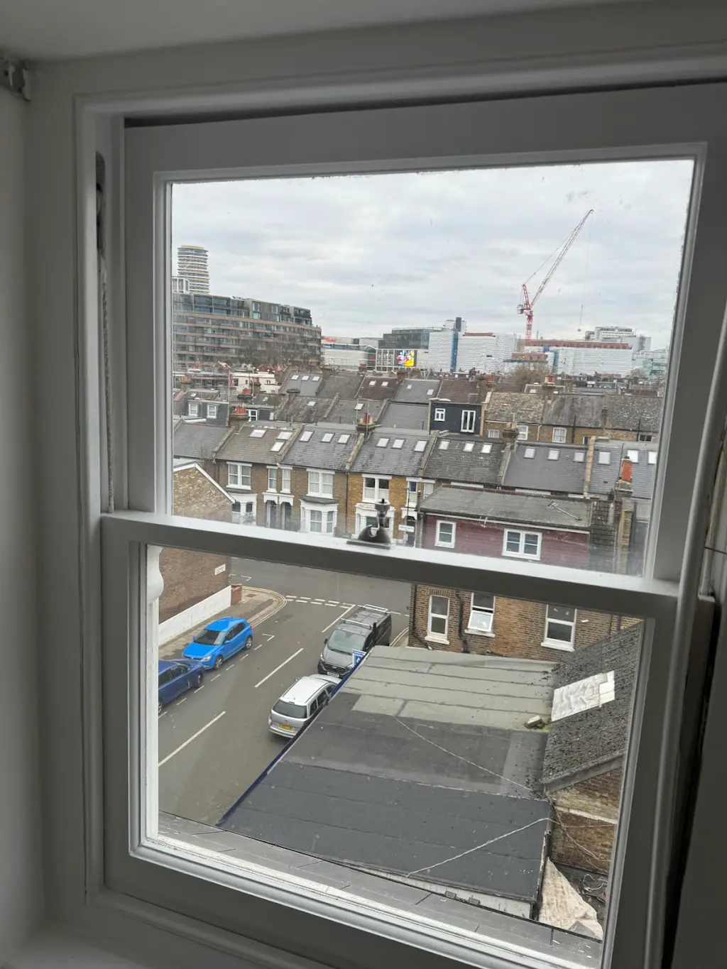 Refurbished sash window overlooking London rooftops and skyline