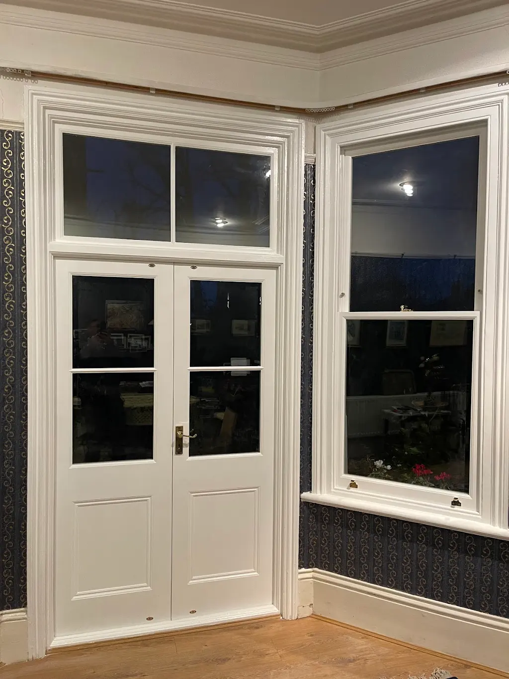 Repainted white internal french doors and bay window in a period living room