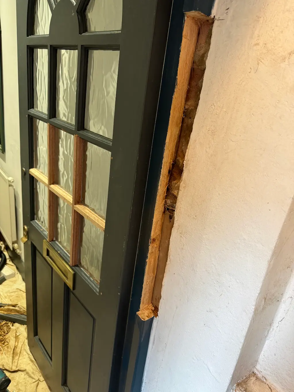 Rotten door frame stripped back to bare timber before repair