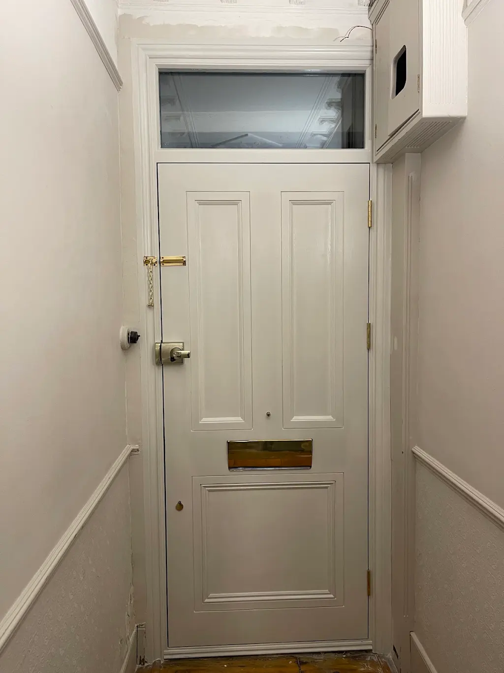 Repainted white internal front door with brass letterplate