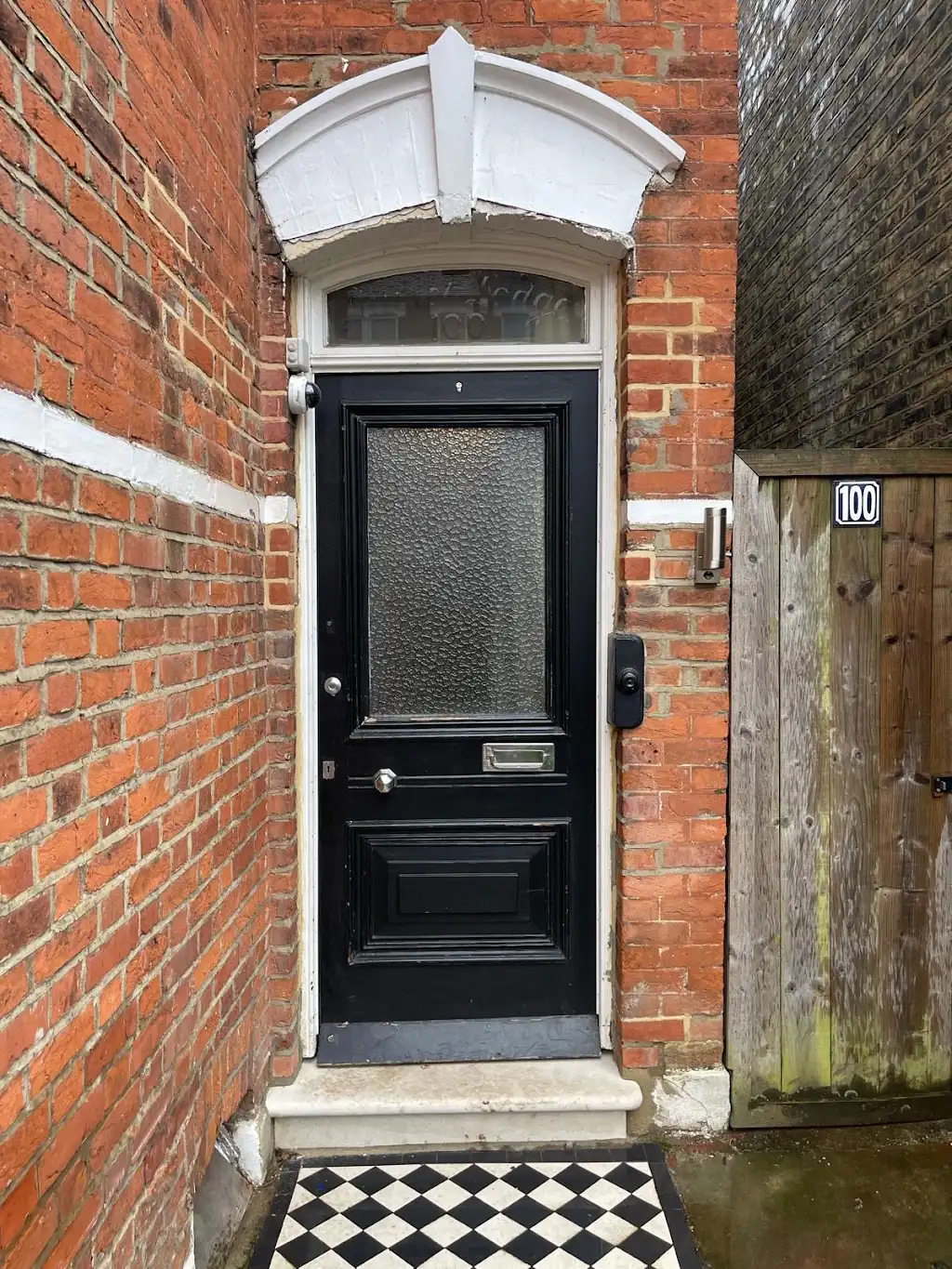 Original black Victorian front door before restoration and repaint