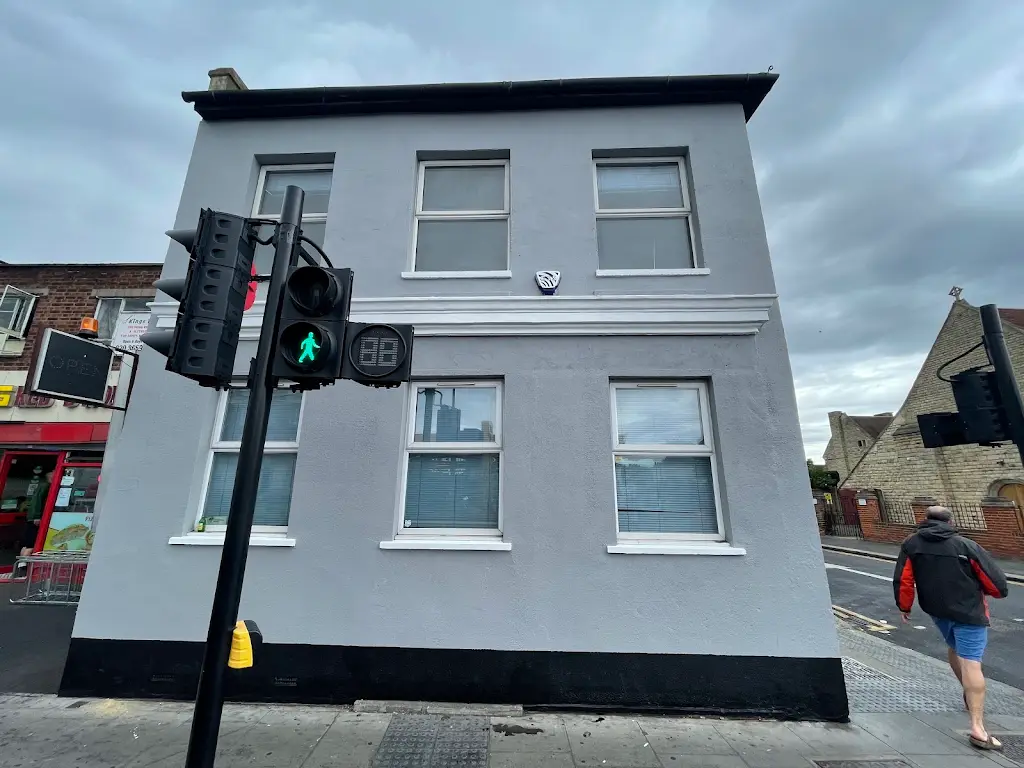 Exterior masonry repainted in soft grey on a corner London property