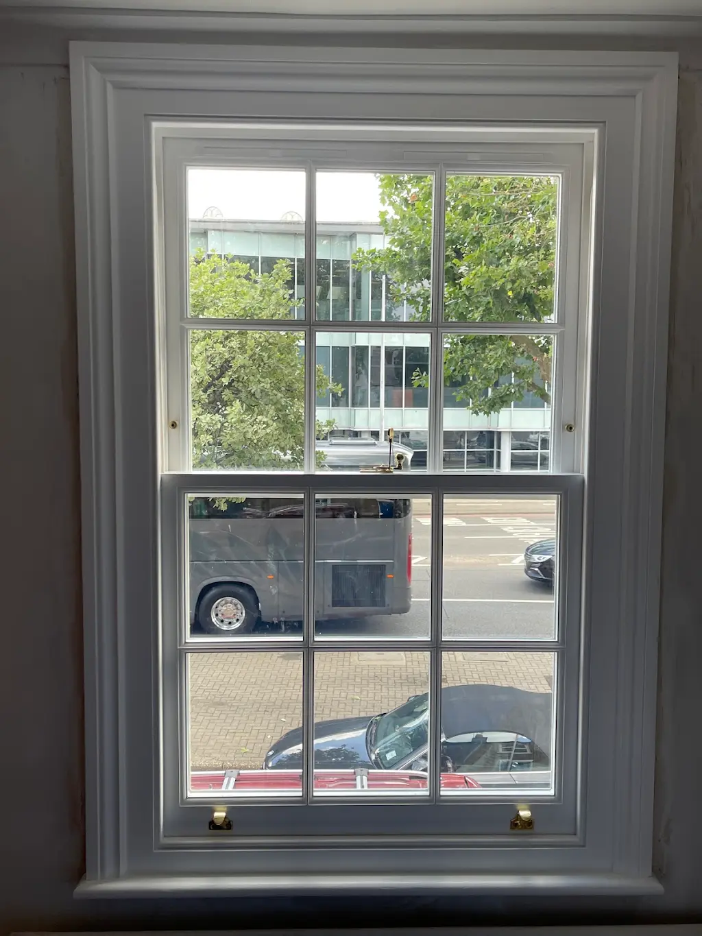 Interior view of a refurbished Georgian-style sash window with brass fittings