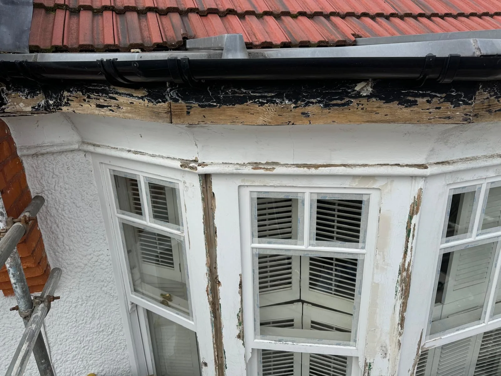 Peeling paint on bay window fascia and frames prepped for timber repair