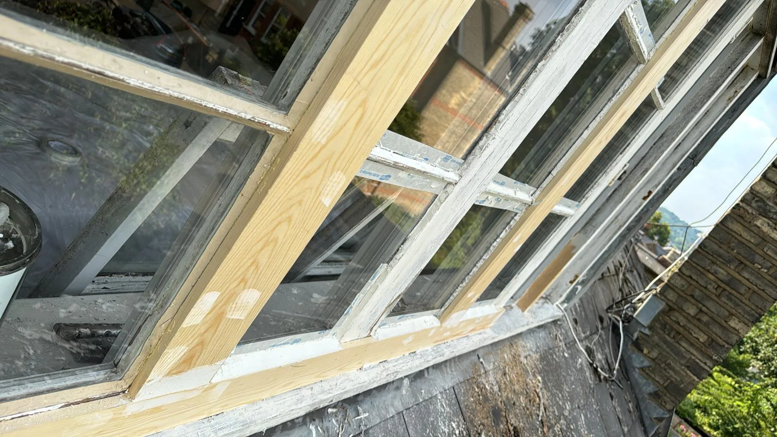 Sash window with fresh hardwood timber repairs spliced into stripped frames
