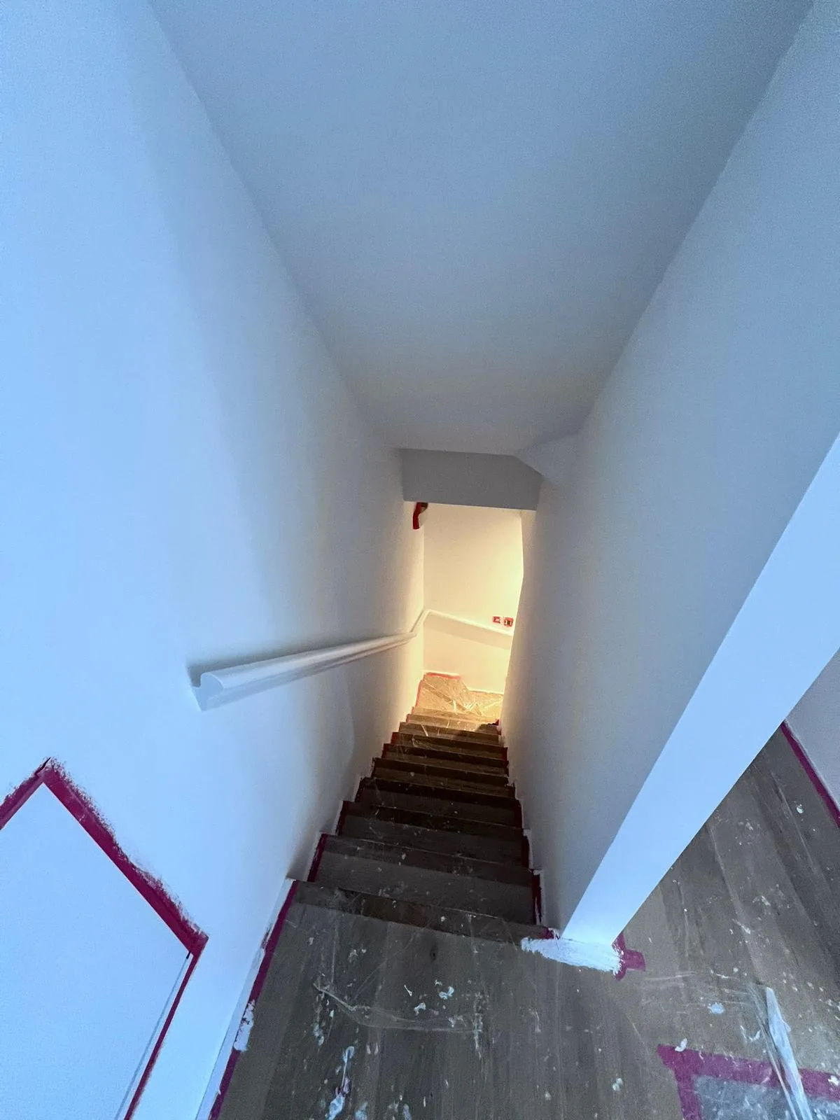 Staircase mid-decoration with covered treads and freshly painted white walls