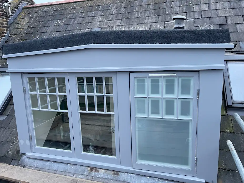 Restored dormer loft windows repainted in soft dove grey