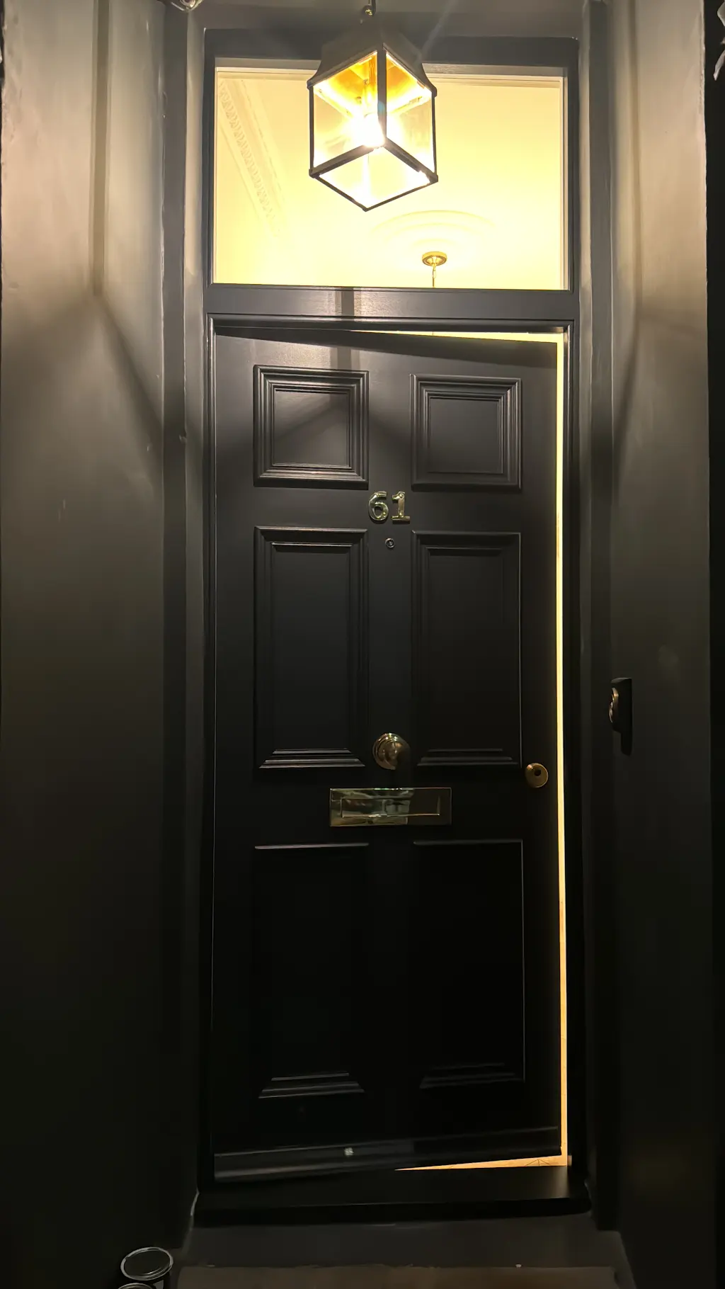 Elegant matte black front door with brass hardware
