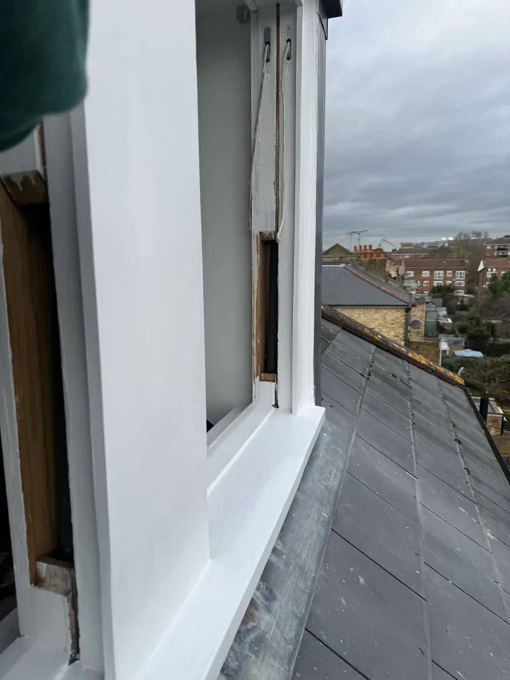 Sash window box repaired and repainted mid-restoration